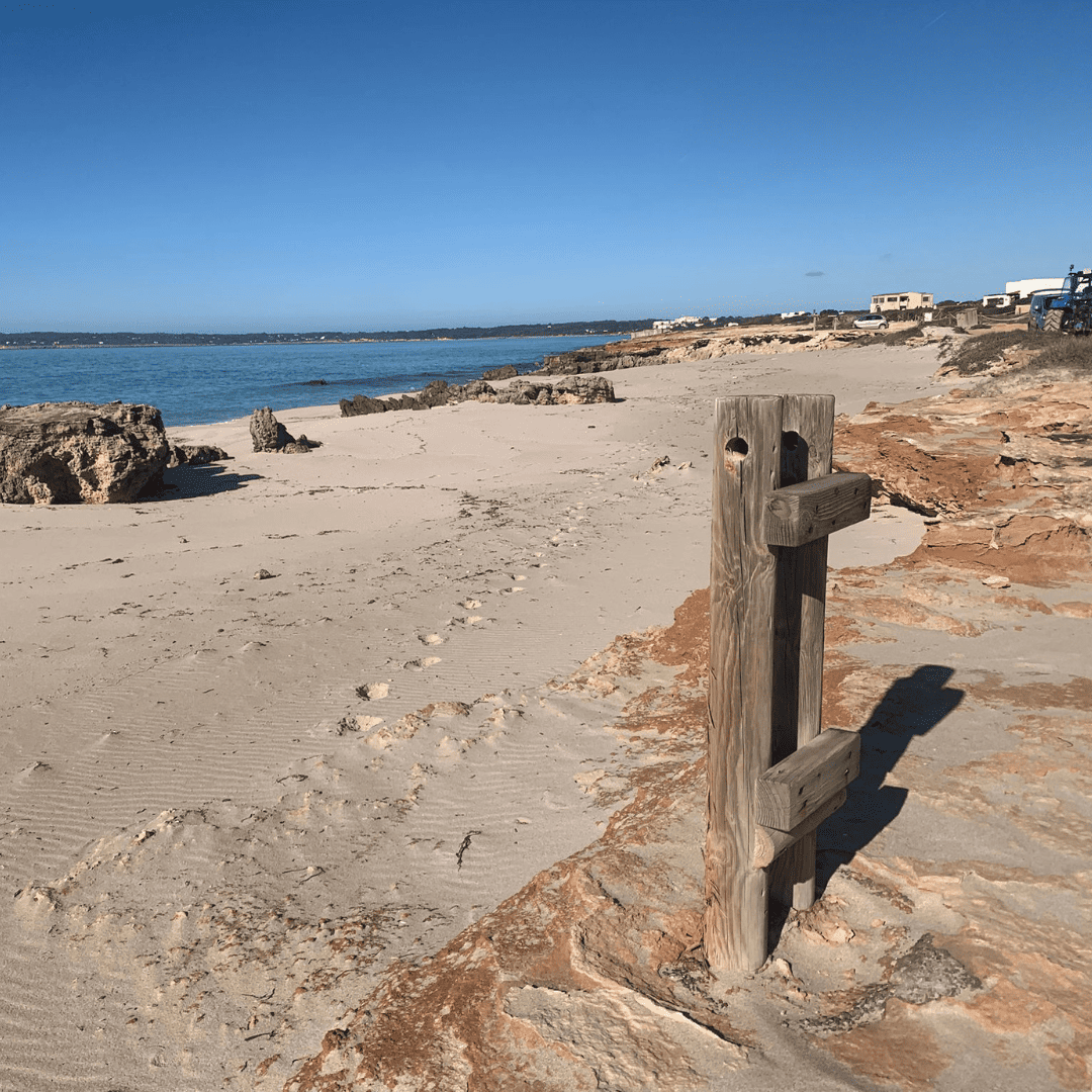 Crystal-clear waters and pebbles at Platja des Còdol Foradat, Formentera